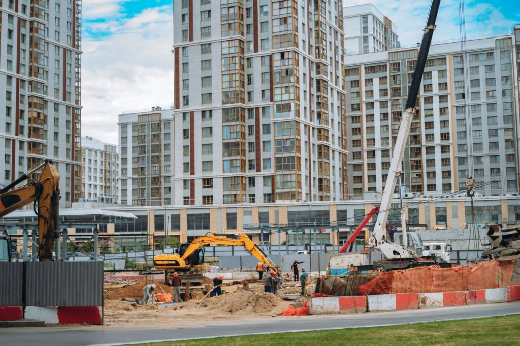 workers and technic work at modern construction site of appartment recidential building in city.